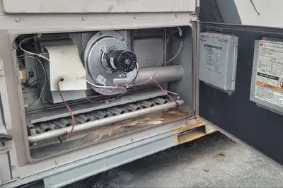 Technician repairing the burner assembly of a gas furnace