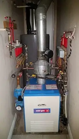 Floor-standing gas boiler with radiant heating manifolds