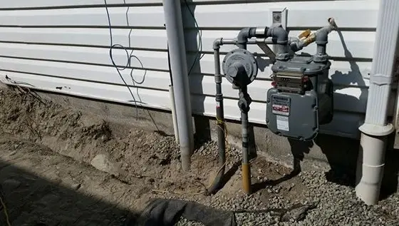 New gas meter and piping on an exterior wall