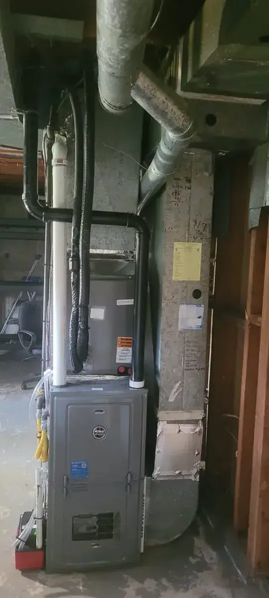 Furnace and heat pump coil with new venting in an unfinished basement