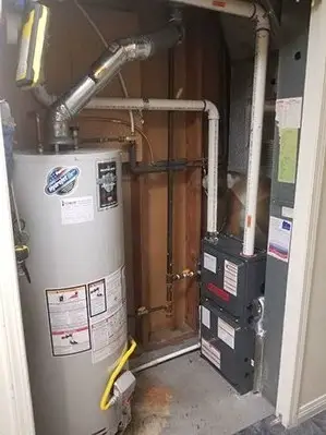 Hot water tank installed beside a furnace