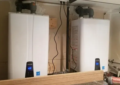 Two new white water heaters installed side by side